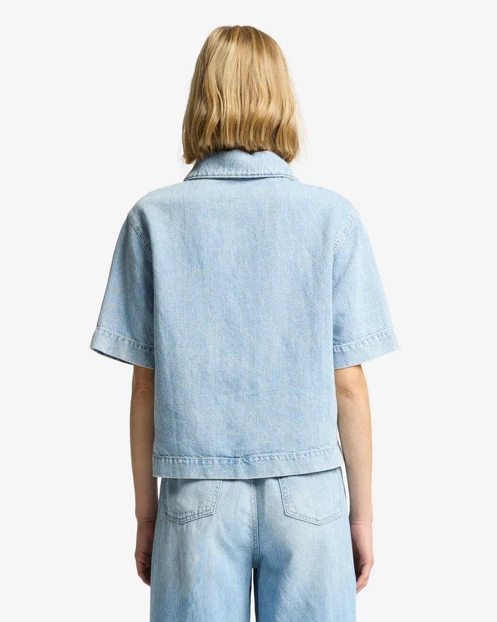 Person wearing a light blue denim jacket and pants 