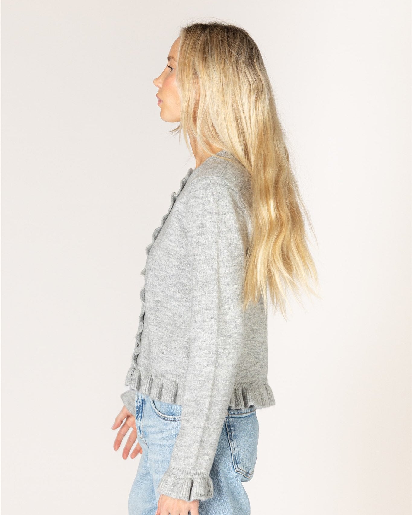 grey cardigan with ruffles down the middle and on sleeves