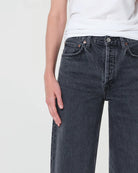 A woman  wearing black wide-leg jeans 