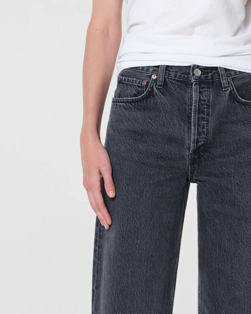 A woman  wearing black wide-leg jeans 