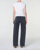 A woman  wearing black wide-leg jeans 