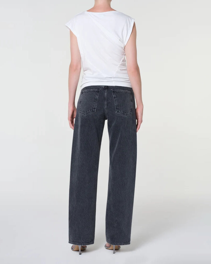 A woman  wearing black wide-leg jeans 