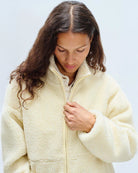 Person wearing a yellow colored fleece jacket with american vintage logo