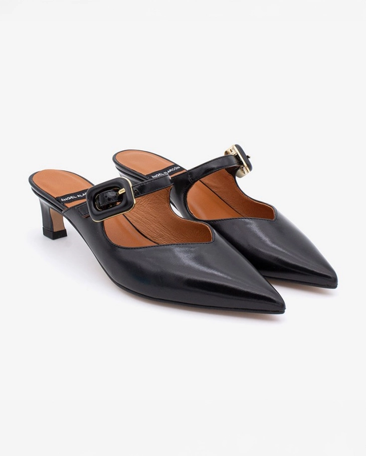 pointed toe mule with an open back and a small heel. Has a strap across the foot that has a black buckle on it