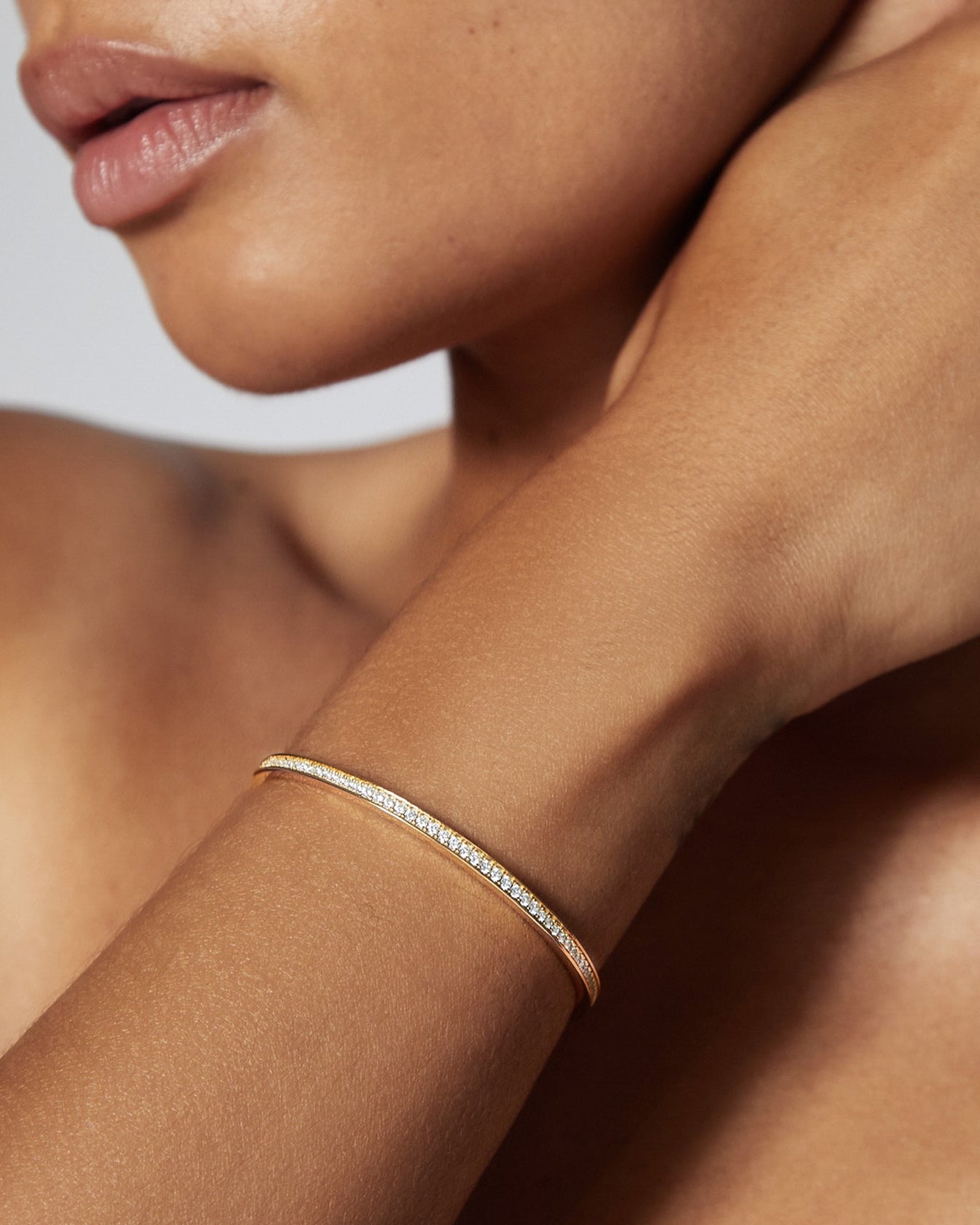 gold cuff bracelet with diamonds in the middle