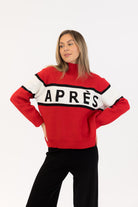 red sweater with whit and black stripe saying apres