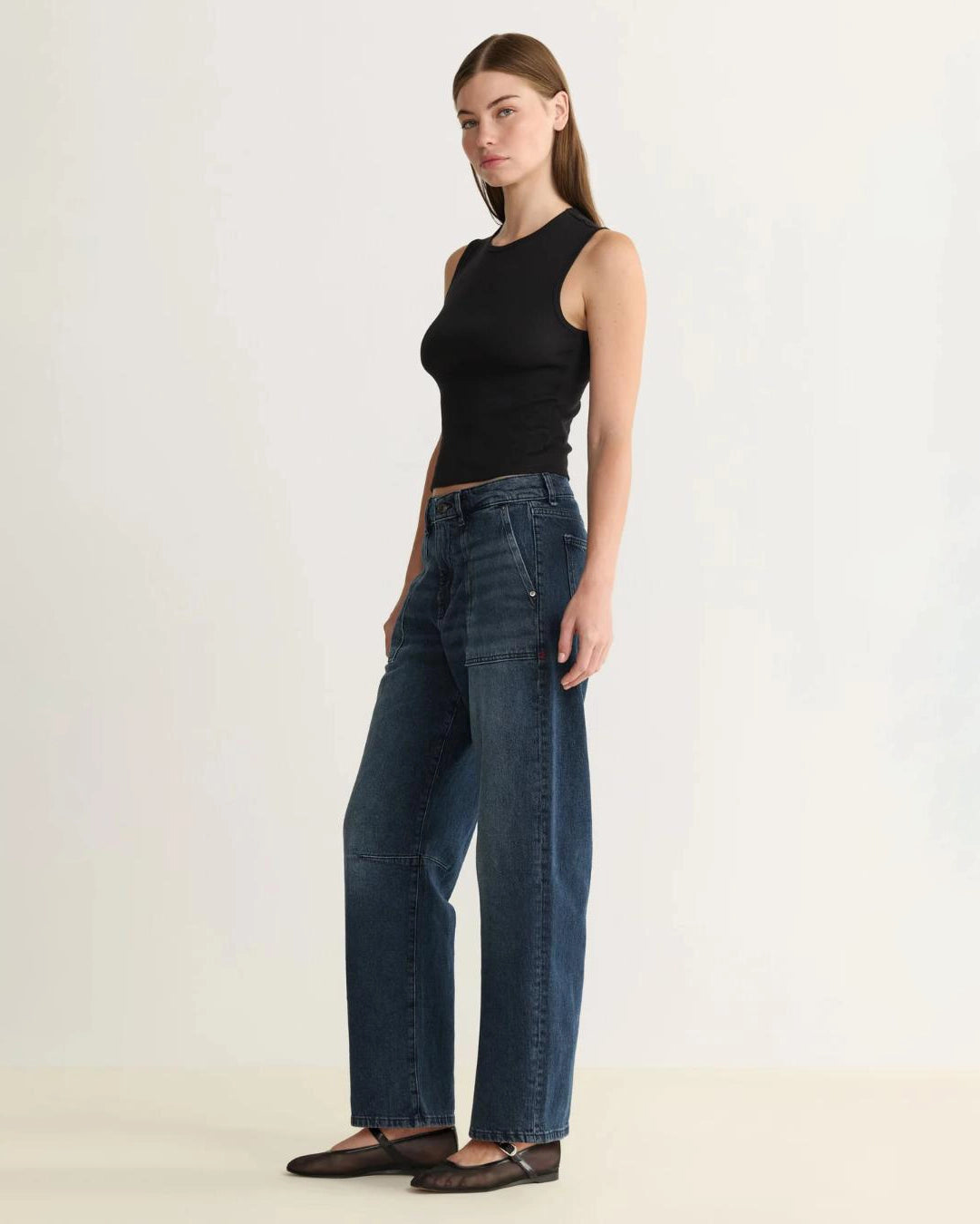 woman wearing barrel blue jeans