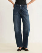 a pair of barrel cut blue jeans 