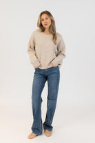 beige sweater with bows on it