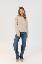 beige sweater with bows on it