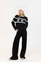 black sweater with ski written on the middle