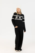 black sweater with ski written on the middle