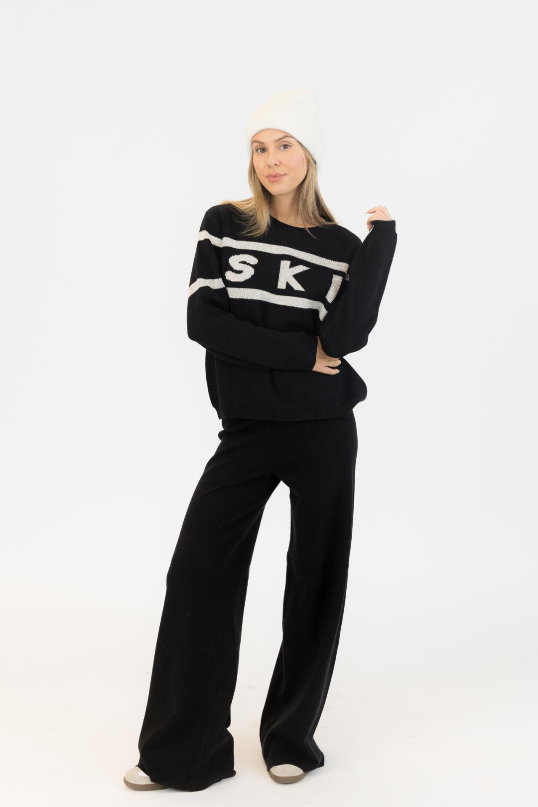 black sweater with ski written on the middle