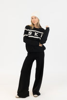 black sweater with ski written on the middle