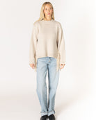 beige knit sweater with tassels on the sides