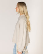 beige knit sweater with tassels on the sides