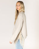 beige knit sweater with tassels on the sides