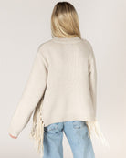 beige knit sweater with tassels on the sides