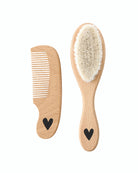 a picture of a baby brush and comb with a small heart on the handle