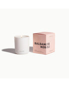 white candle that comes in a pink box