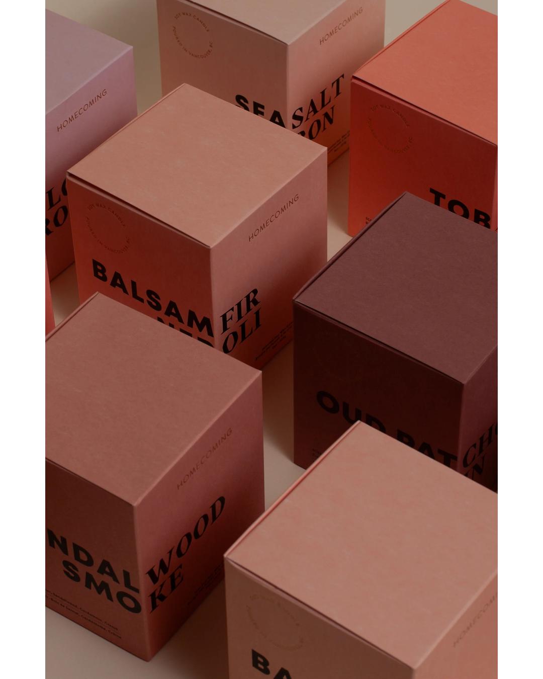white candle that comes in a pink box