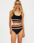 Woman wearing a black and red and beige striped bikini set 