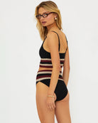 Woman wearing a black and red and beige striped bikini set 