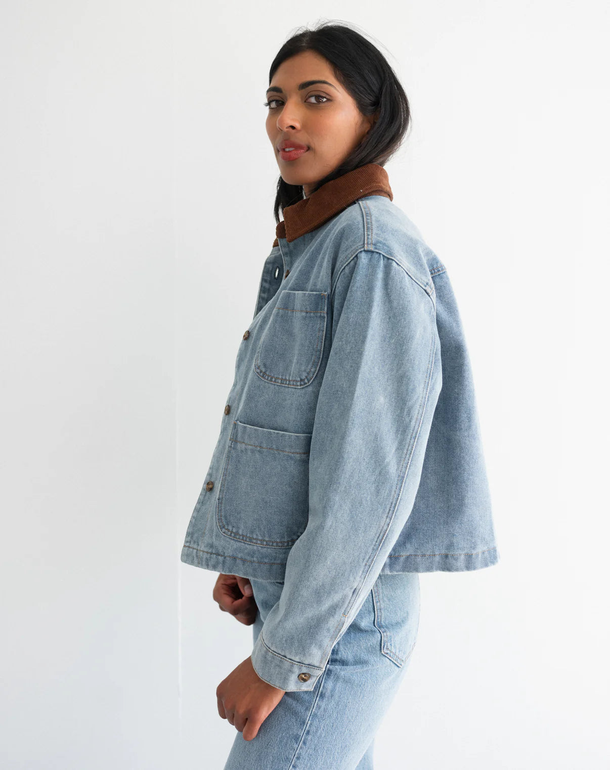 woman wearing denim jacket with brown corduroy collar