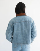 woman wearing denim jacket with brown corduroy collar