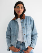 woman wearing denim jacket with brown corduroy collar