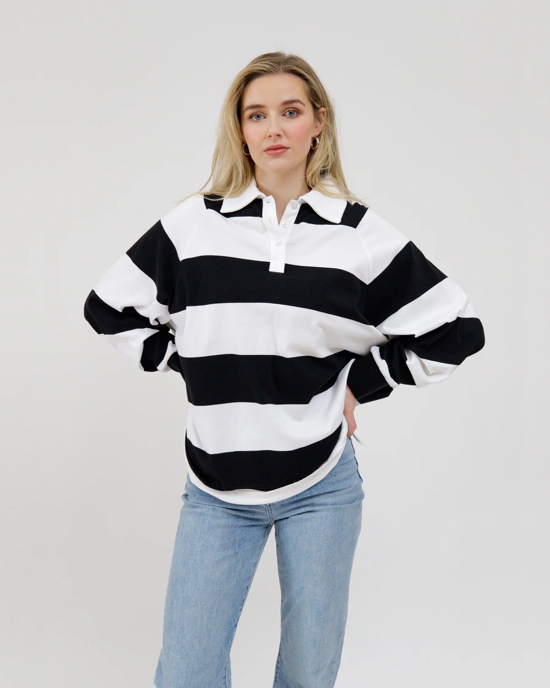 woman wearing a black and white striped rugby shirt 