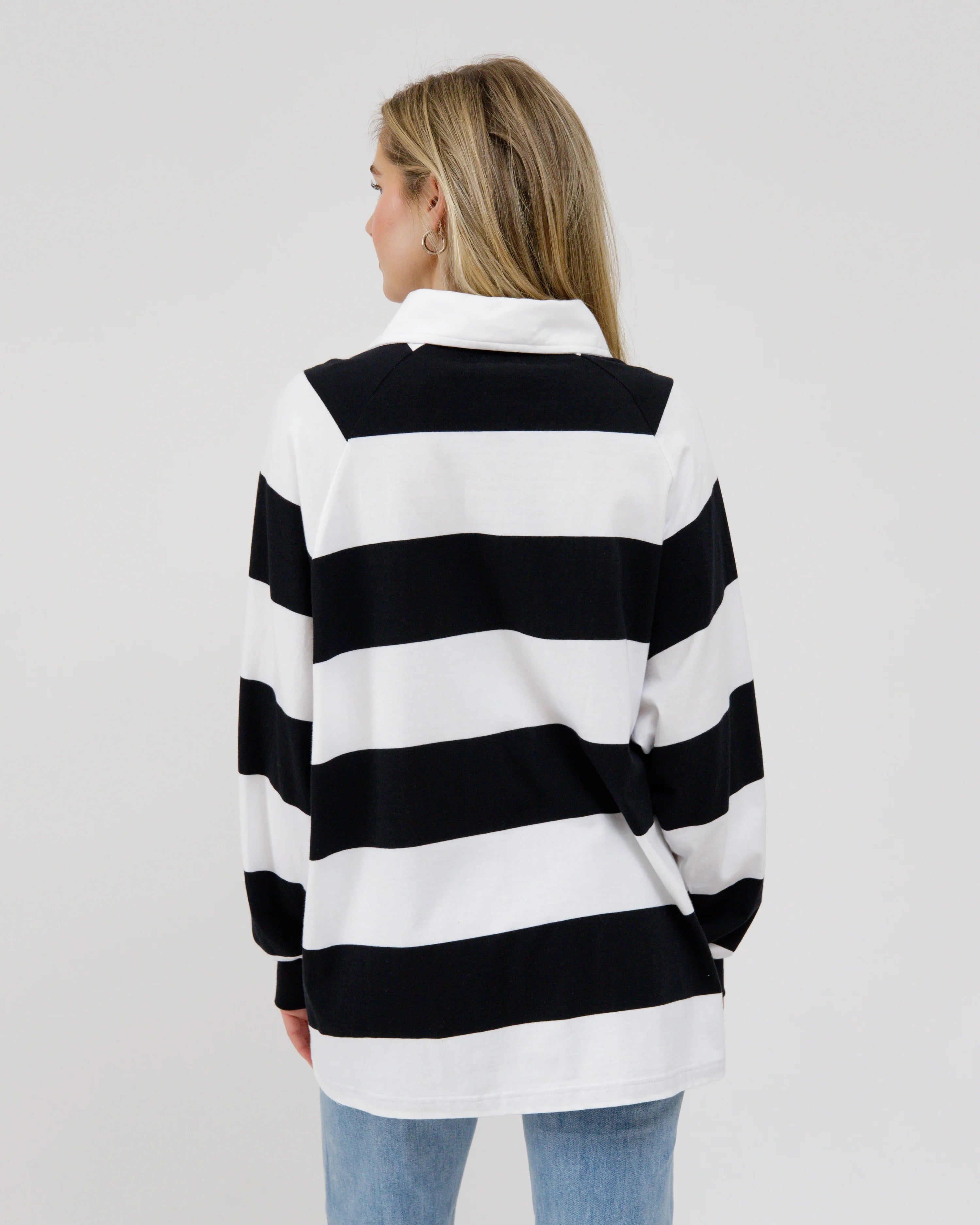 woman wearing a black and white striped rugby shirt 