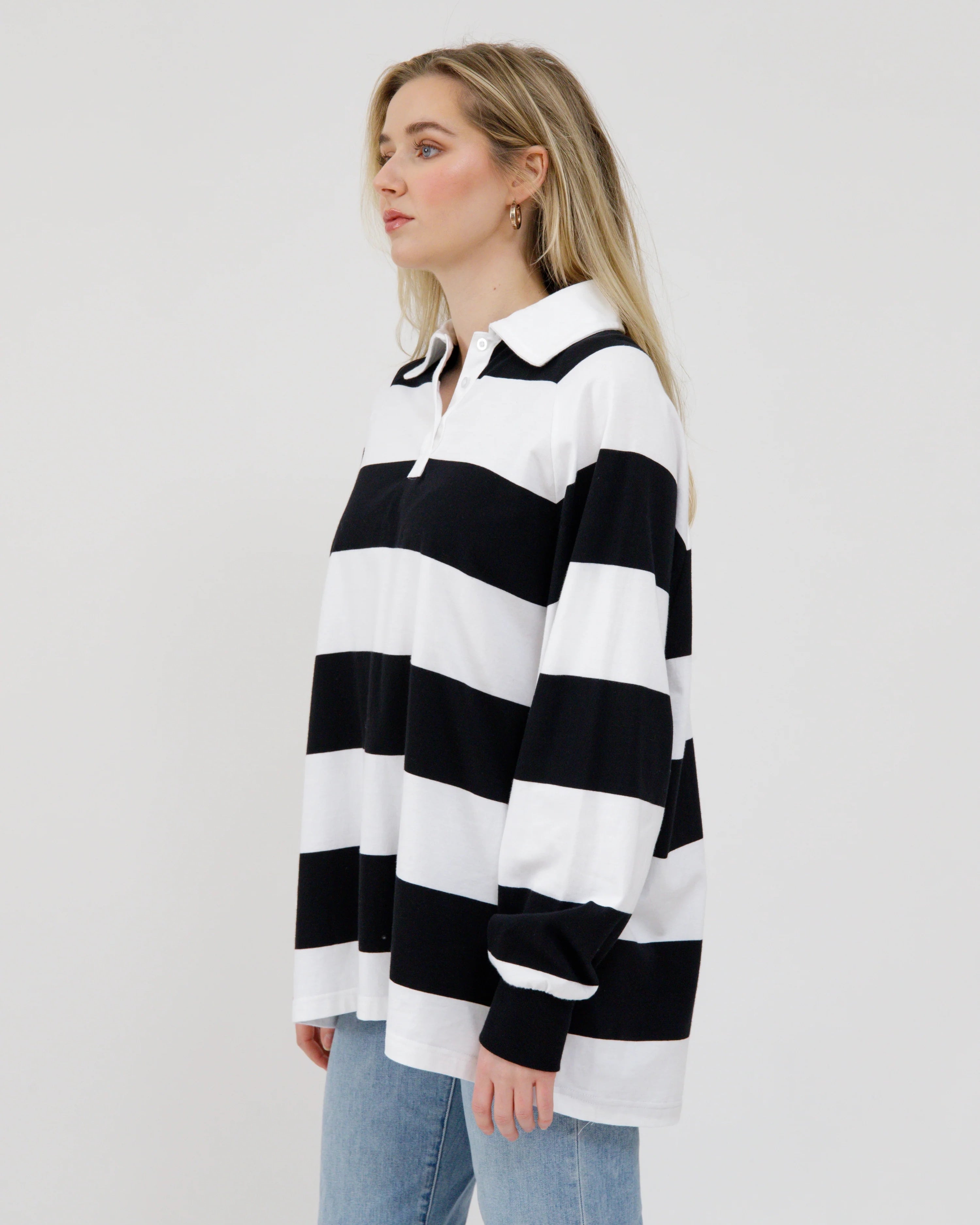 woman wearing a black and white striped rugby shirt 