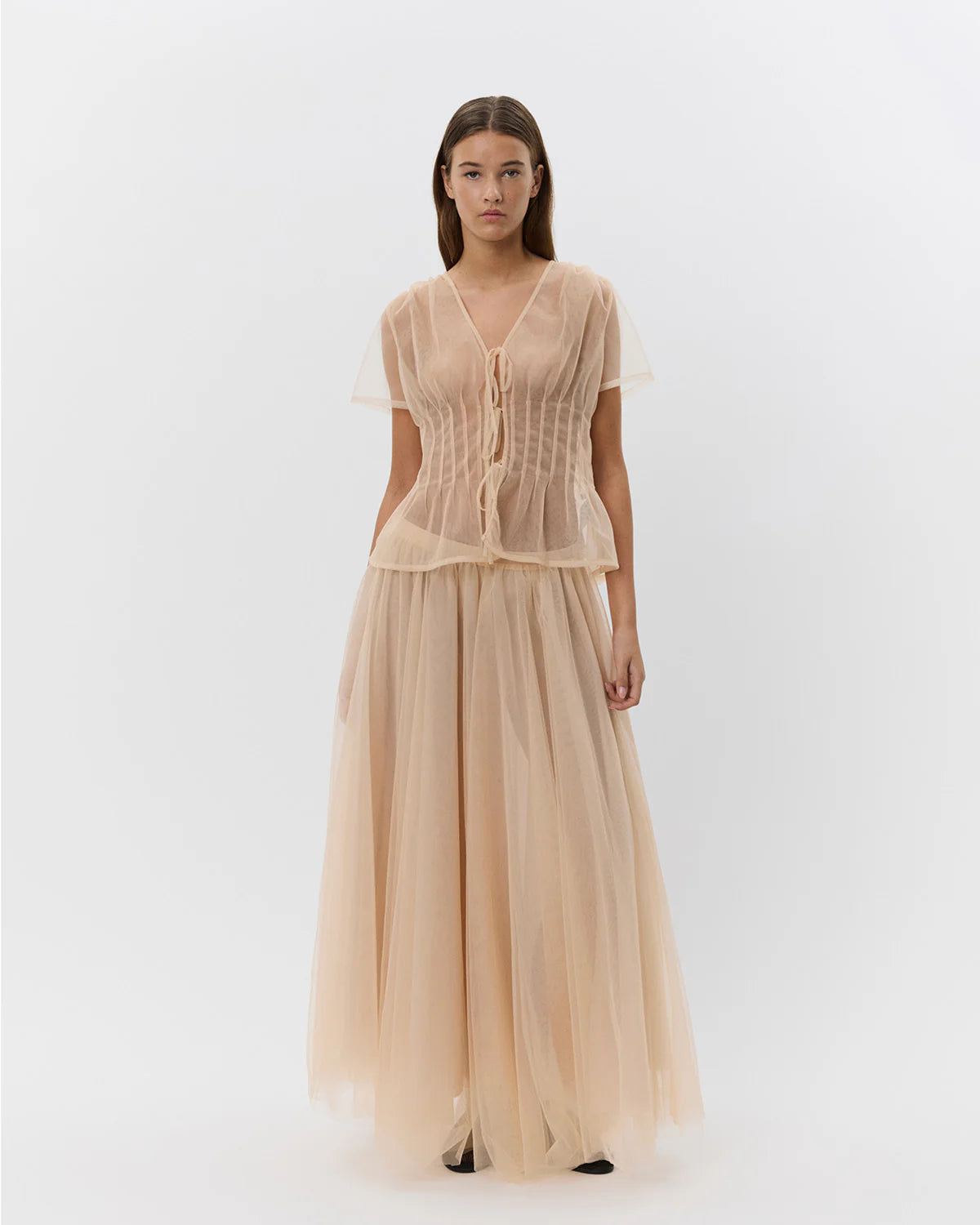a blush coloured blouse that ties closed 