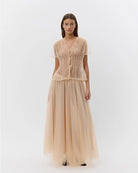a blush coloured blouse that ties closed 
