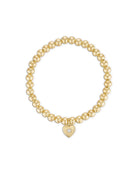 Gold beaded bracelet with a heart-shaped charm 