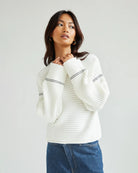 Woman wearing a white ribbed sweater
