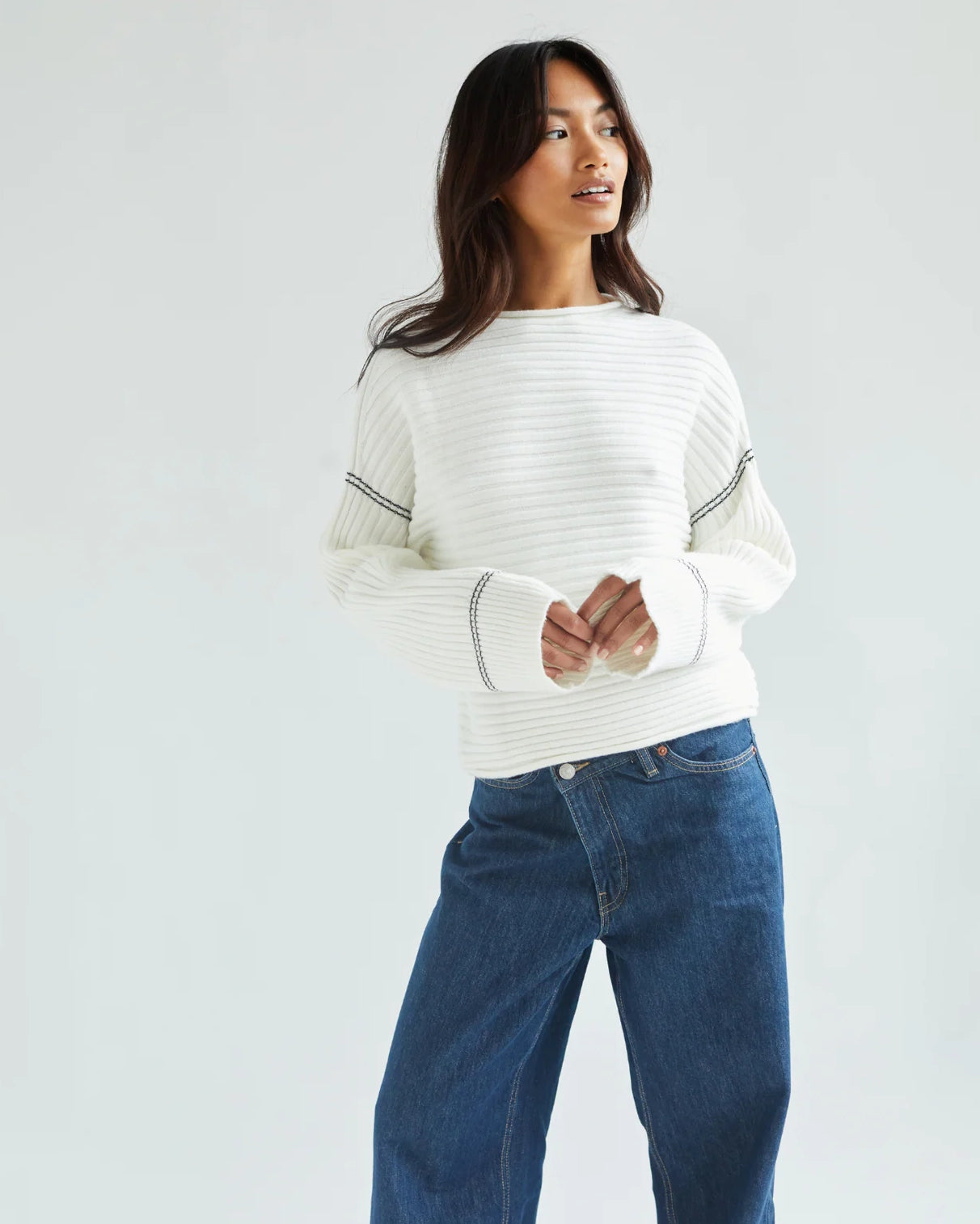 Woman wearing a white ribbed sweater