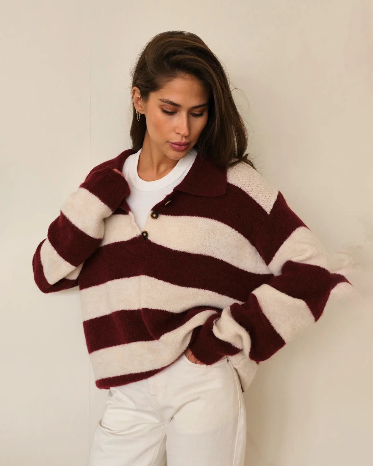 Woman wearing a maroon and white striped fluffy sweater 