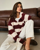 Woman wearing a maroon and white striped fluffy sweater 