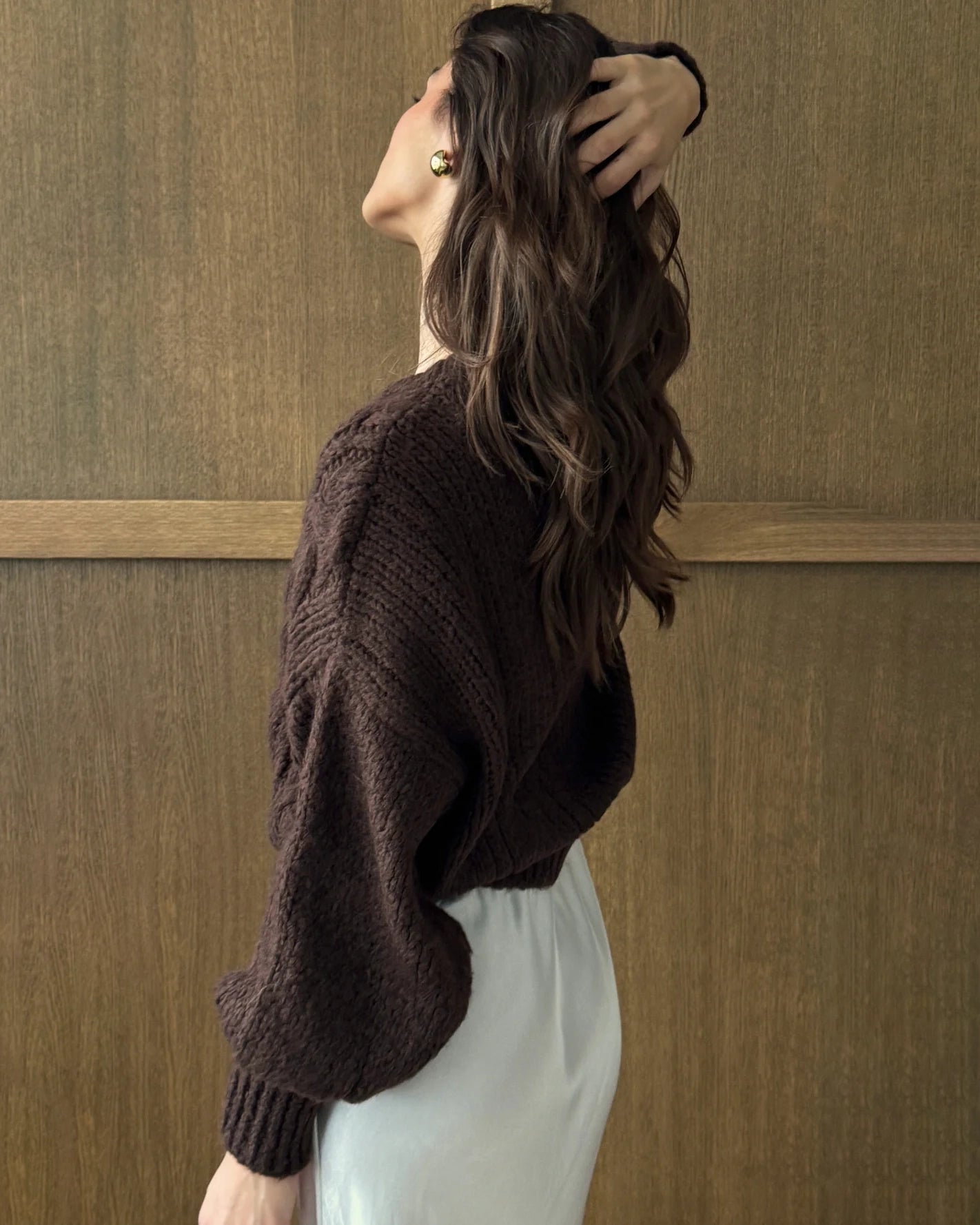 Woman wearing a brown cable knitted cardigan 