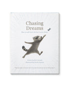 Cover of Children's Book called 'Chasing Dreams: how to add more daring to your doing' by Kobi Yamada with a raccoon reaching for a butterfly