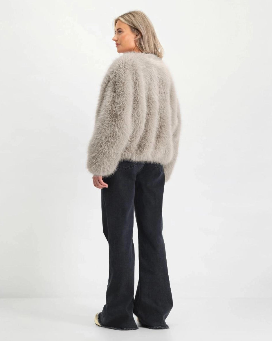 a woman wearing black flared denim jeans