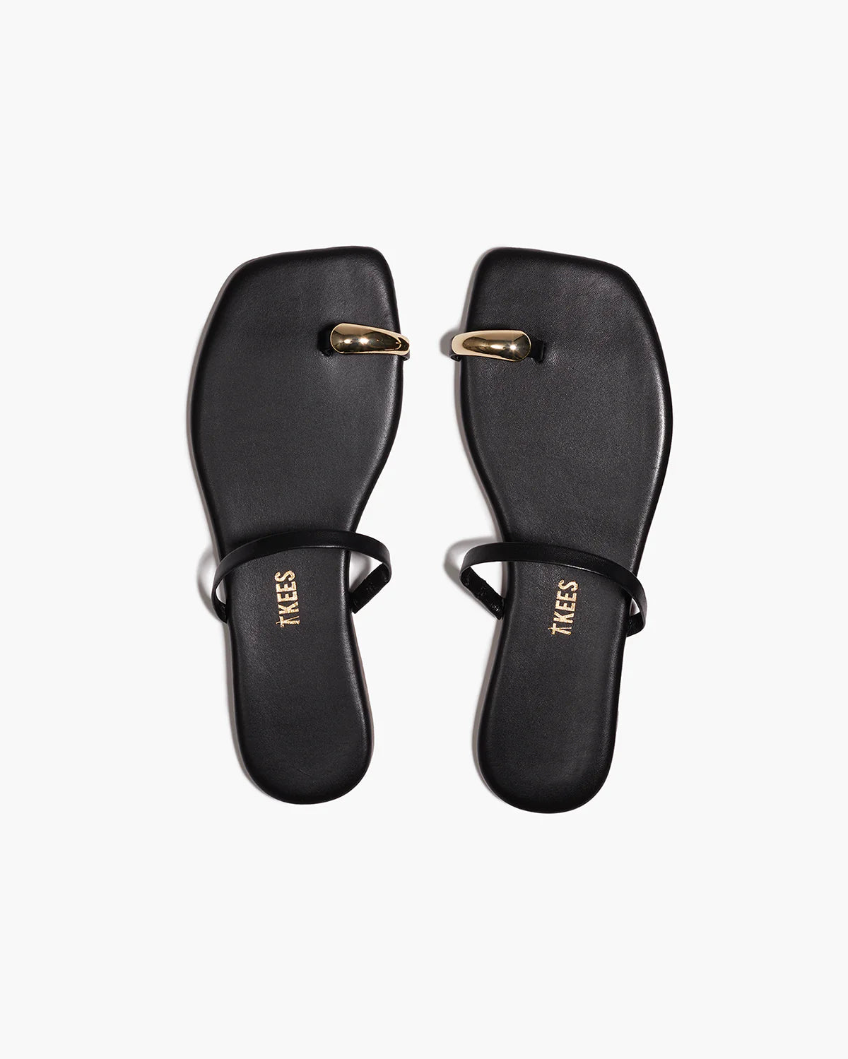 black sandal with gold toe piece 
