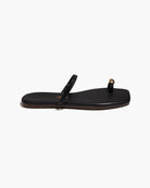 black sandal with gold toe piece 