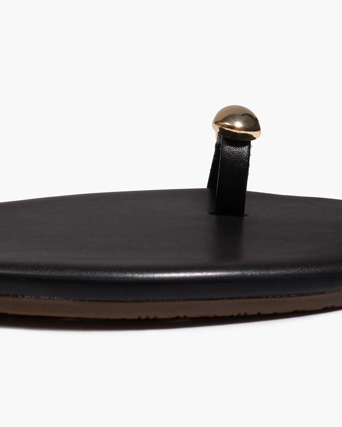 black sandal with gold toe piece 