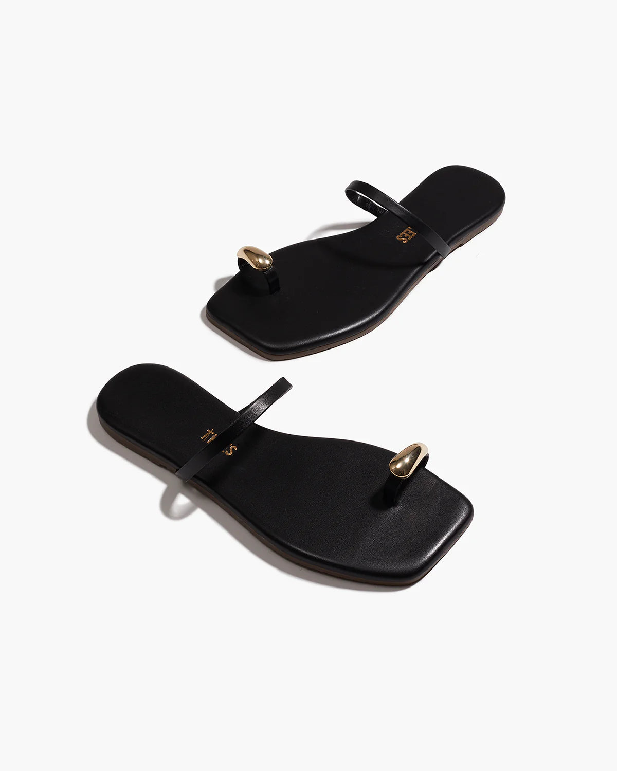 black sandal with gold toe piece 