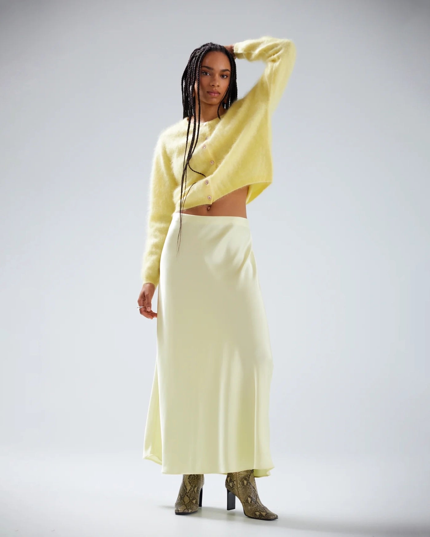 Woman wearing a light yellow brushed cashmere button down cardigan
