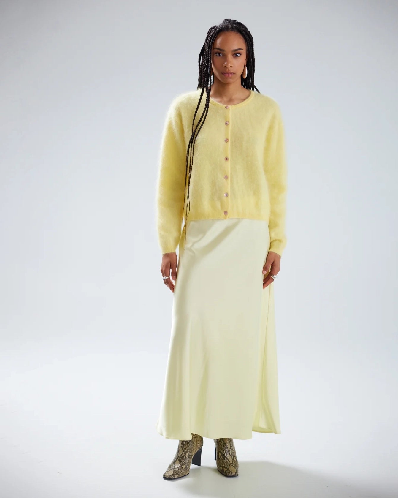 Woman wearing a light yellow brushed cashmere button down cardigan