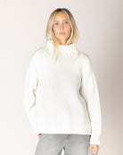 grey cardigan with ruffles down the middle and on sleeves